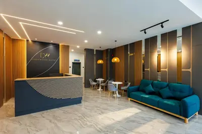 a lobby with a blue couch and a bar at Edenwood Hotel in George Town
