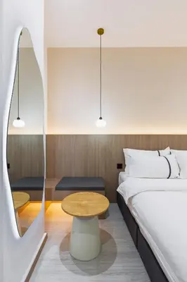 a hotel room with a bed and a table at Edenwood Hotel in George Town