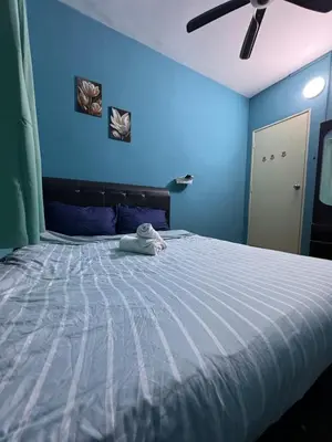 a blue bedroom with a bed with a blue wall at 1Br 2pax 1car only Malaysian guest only in Bayan Lepas