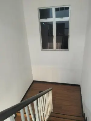 a staircase with a window and a wooden floor at Tenang Tambun House in Tanjung Rambutan