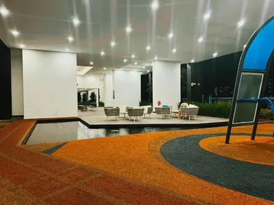 a lobby of a building with a table and chairs at Modern 3BR Getaway Perfect for Families & Groups 10 pax in Jelutong