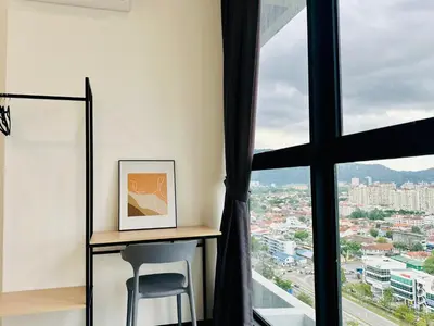a desk in a room with a large window at Spacious 3BR Retreat Comfort & Convenience in Prime Location 2-10pax in Jelutong