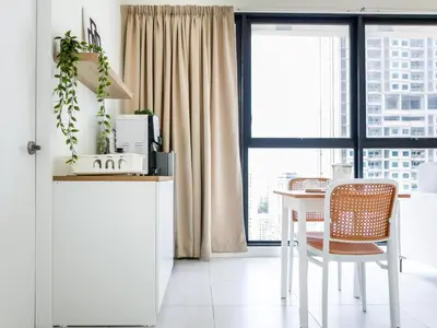 a kitchen with a table and a chair and a window at Urban Seaview Home in George Town
