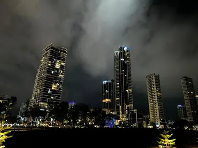 a city skyline with tall buildings at night at Comfortable 2BR 5 Queen Beds, Netflix & Free Parking in Jelutong