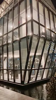 a glass building with a bunch of windows at Comfortable 2BR 5 Queen Beds, Netflix & Free Parking in Jelutong