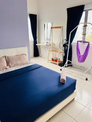a bedroom with a blue bed in a room at Rayyan'Homestay PRIMA in Tanah Rata
