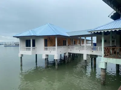 a house on a pier in the water at Capital O 91118 Chalet Seri Idaman in Kampong Batu Maung