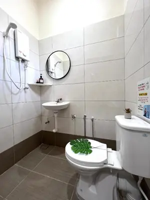 a bathroom with a toilet with a green plant on it at The Little Bali Romance 2pax#Private Bathroom#2min KekLokSi in Ayer Itam