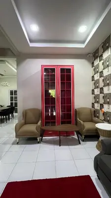a living room with two chairs and a coffee table at Md homestay in Kampong Kubang Menderong