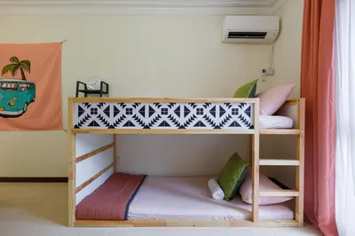 two bunk beds in a small room with at EEs Ocean House - Homestay 3 min walk to beach in Batu Ferringhi