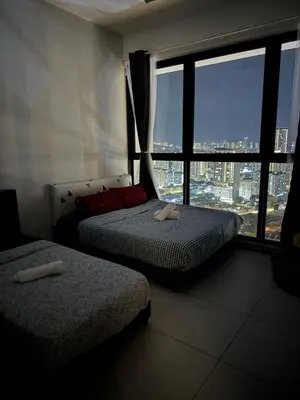 a bedroom with two beds and a large window at Bright & airy 3BR homestay comfort penang Netflix in George Town