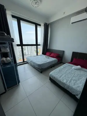 a bedroom with two beds and a large window at Bright & airy 3BR homestay comfort penang Netflix in George Town