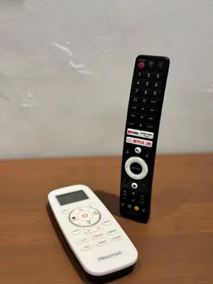 a remote control sitting on top of a wooden table at Industrial Loft Tinyhouse Homestay - 2 Queen Bed, Free Netflix, Prime & Wi-Fi Near Bukit Mertajam in Kubang Semang