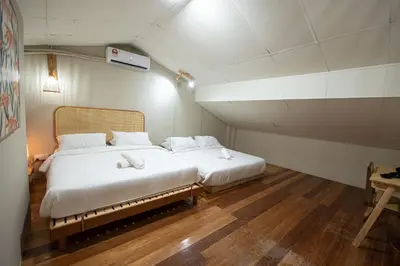 a bedroom with two beds in a small room at DeLuma - Lebuh Melayu 4 Bedroom in George Town