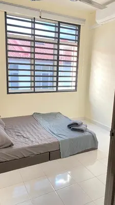 a bed in a room with a large window at Assyifa Homestay Kulim in Kulim