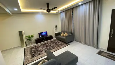a living room with a couch and a tv at Assyifa Homestay Kulim in Kulim