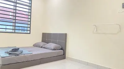 a bed in a white room with a window at Assyifa Homestay Kulim in Kulim