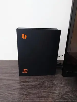 a black box sitting on the floor next to a tv at Homestay Bunga Raya Wifi Netflix in Sitiawan