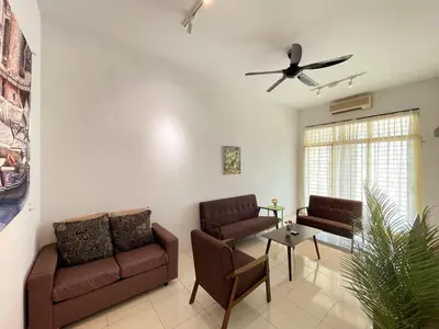 a living room with two couches and a ceiling fan at Jovial Single Storey Cozy Haus 9Pax in Lunas