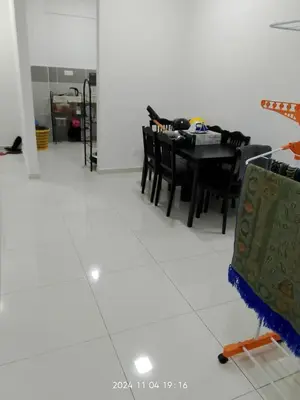 a dining room with a table and black chairs at Prima Resident Meru Ipoh in Ipoh