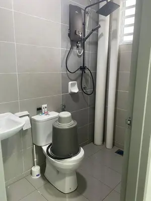a bathroom with a toilet with a green tank at Prima Resident Meru Ipoh in Ipoh