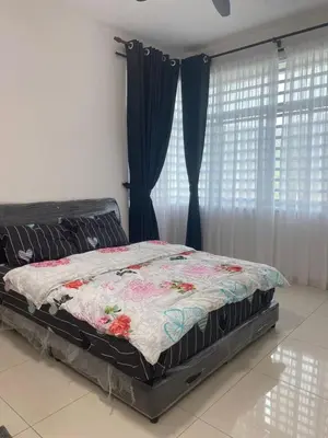 a bed with a quilt on it in a bedroom at Prima Resident Meru Ipoh in Ipoh