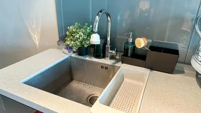 a kitchen counter with a sink with a sink at Penang Oceanview Loft in George Town