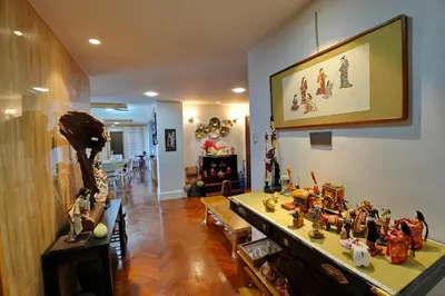 a living room filled with lots of figurines on a table at Japan Comfort Lifestyle Hokkaido in Ipoh