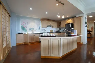 a large kitchen with wooden cabinets and a counter top at Japan Comfort Lifestyle Nagoya in Ipoh
