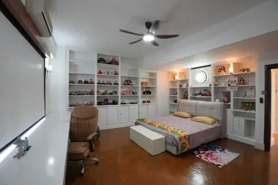 a bedroom with a bed and a chair and a clock at Japan Comfort Lifestyle Nagoya in Ipoh