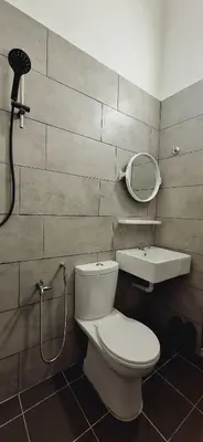 a bathroom with a toilet and a sink and a mirror at Ipoh Meru Landed Homestay TropiCasa 28 in Ipoh
