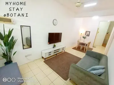 a living room with a couch and a tv at MyHomestay Botani in Ipoh