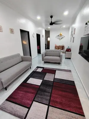 a living room with two couches and a rug at Suria Permai19 Homestay in Taiping
