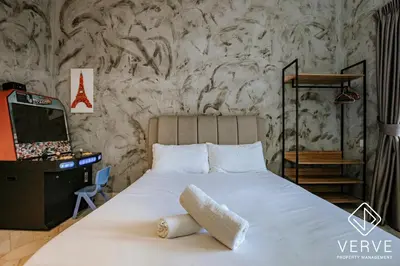 a bedroom with a white bed and a tv at R Private Club House 4B4B 16 pax by Verve in Ipoh
