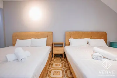 two beds sitting next to each other in a room at R Private Club House 4B4B 16 pax by Verve in Ipoh