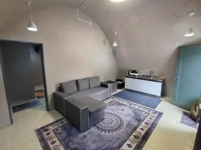 a living room with a couch and a table at Dome Glamping Lojing Highlands in Ladang Pangoi