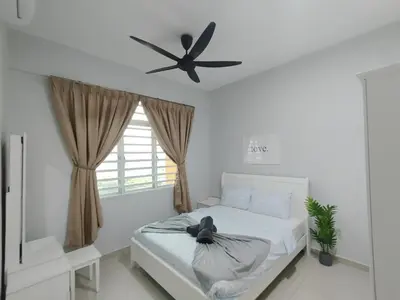 a bedroom with a bed with a ceiling fan at The Paloh Town Suites 4R2B with 2 carpark by IWH Suites in Ipoh