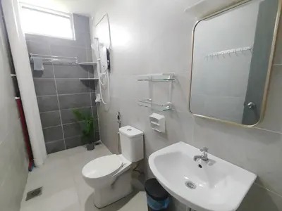 a white bathroom with a toilet and a sink at The Paloh Town Suites 4R2B with 2 carpark by IWH Suites in Ipoh