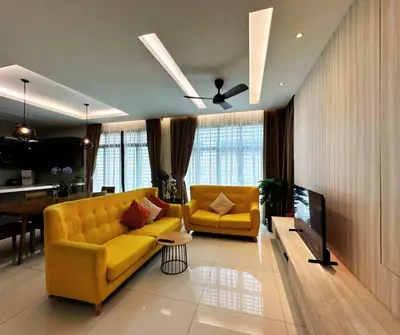 a living room with a yellow couch and a tv at Large Family Villa Beach & Night Market Steps Away 20 Pax in Batu Ferringhi