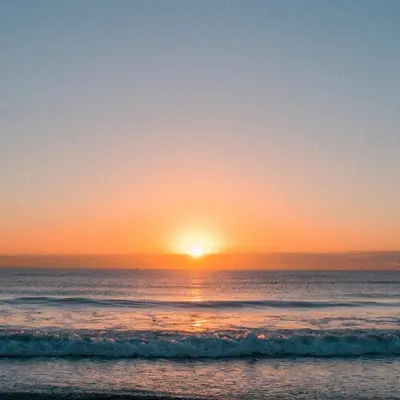 a sunset on the beach with the ocean at Large Family Villa Beach & Night Market Steps Away 20 Pax in Batu Ferringhi