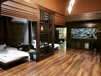 a bedroom with two beds and a room with wooden floors at 30A Studio Room Medan Ipoh with Pool Table in Ipoh
