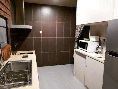 a small kitchen with a sink and a microwave at 30A Studio Room Medan Ipoh with Pool Table in Ipoh