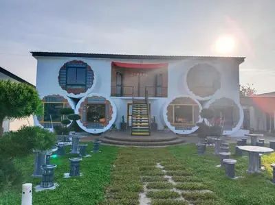 a white building with a garden in front of it at Olly de Home Ent in Batu Gajah