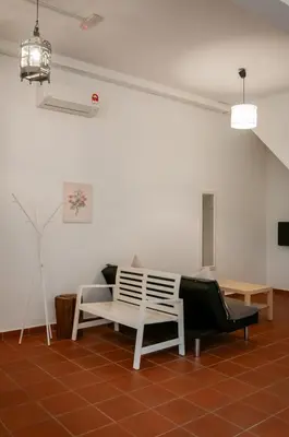 a living room with two chairs and a couch at Aayu Church St - 7 mins to Esplanade, George Town in George Town