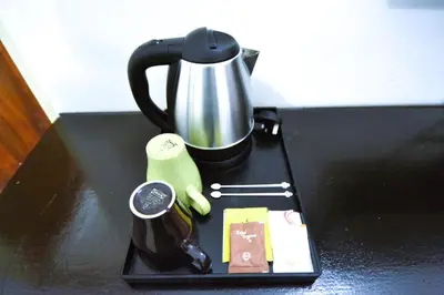 a black tray with a coffee pot on a table at AZYA Hotel in TanjongMalim