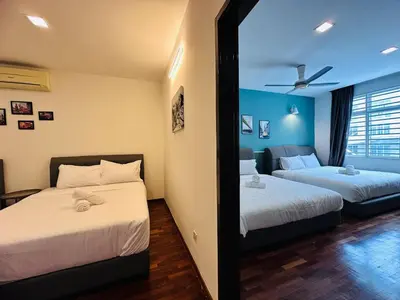 a bedroom with two beds and a mirror at Shamrock Bay Haven 5BR Homestay for 22pax at B Ferringghi in Batu Ferringhi