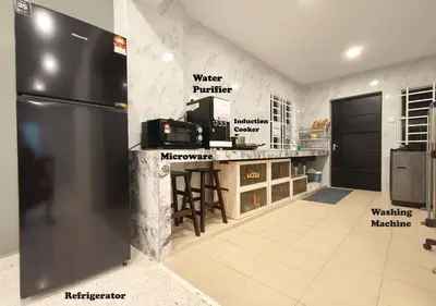 a kitchen with a stainless steel refrigerator and a counter at Fair Park 2 at Ipoh Town Center in Ipoh