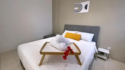 a hotel room with a bed with a tray with towels at BM IconCity Landed Home by Wemestay - Near AutoCity, Juru, Penang Bridge in Bukit Mertajam