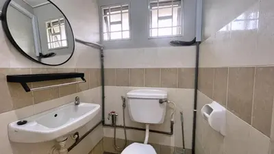 a bathroom with a toilet and a sink and a mirror at BM IconCity Landed Home by Wemestay - Near AutoCity, Juru, Penang Bridge in Bukit Mertajam