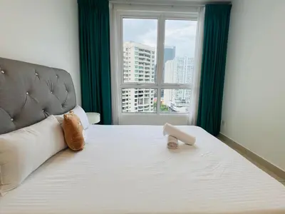 a bedroom with a large bed with a window at Mansion One l 7 pax 2R2B l Cityview l Gleneagles l by PerfectSweetHome in George Town